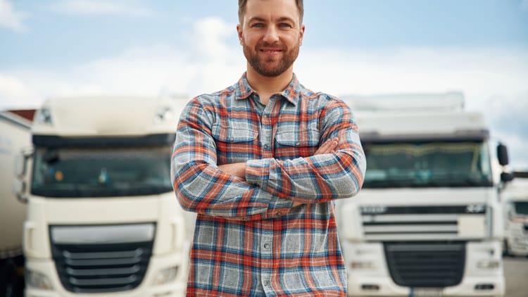 man standing with arms folded in front of motorhomes as the first time RV buying guide